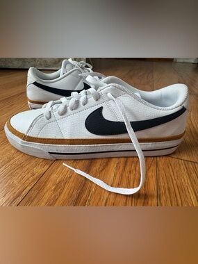 Nike White Low-Top Sneakers with Black Swoosh and Tan Stripe